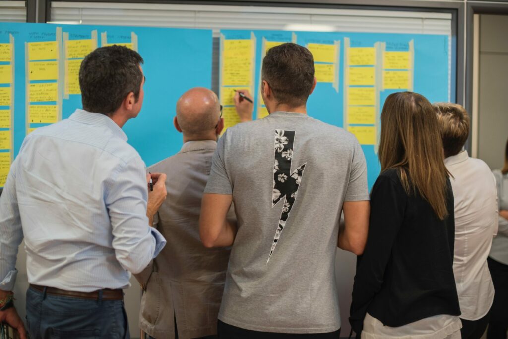 A group of people looking at a poster with notes on it